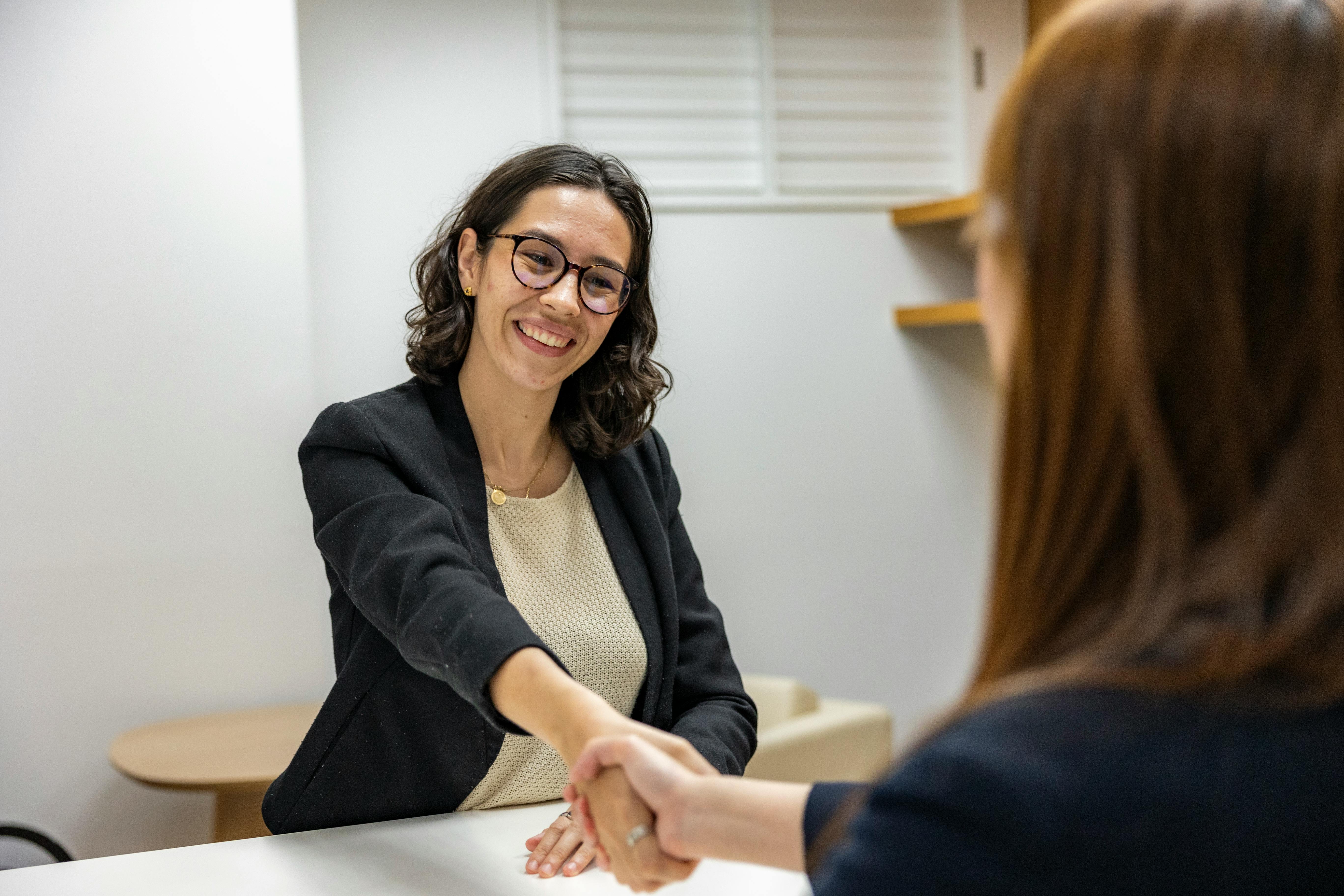 A woman shaking hands after an interview.