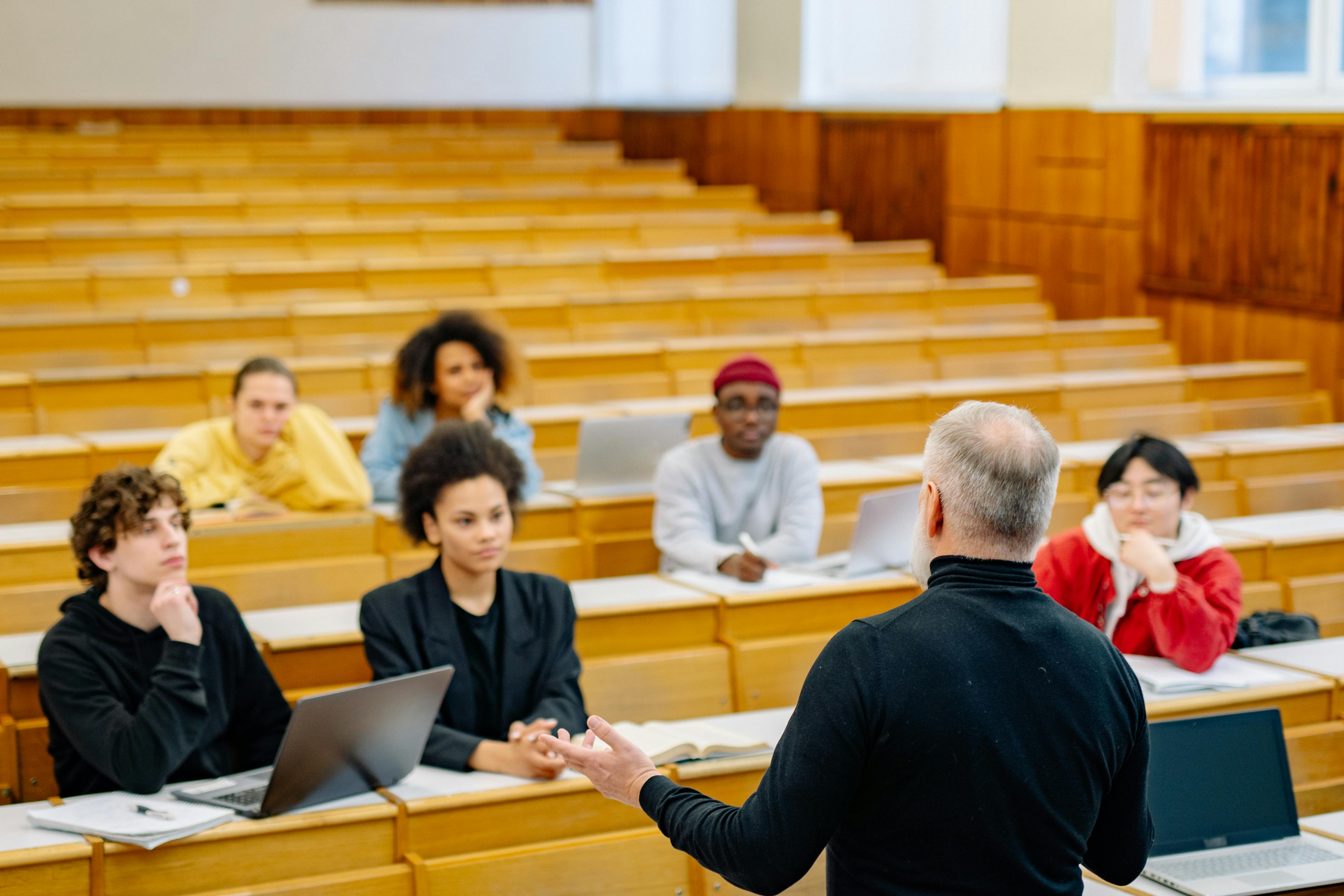 A professor lecturing a class of students.