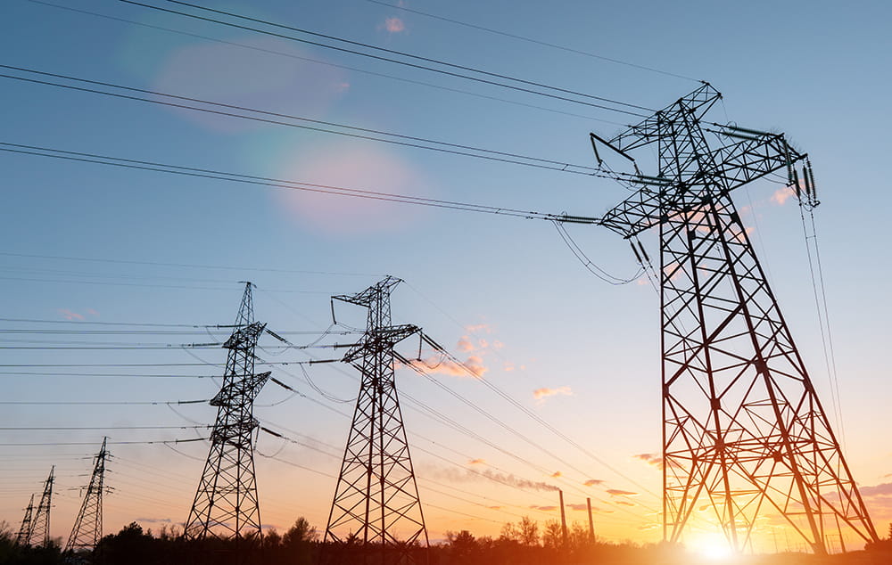 power lines against a sunrise