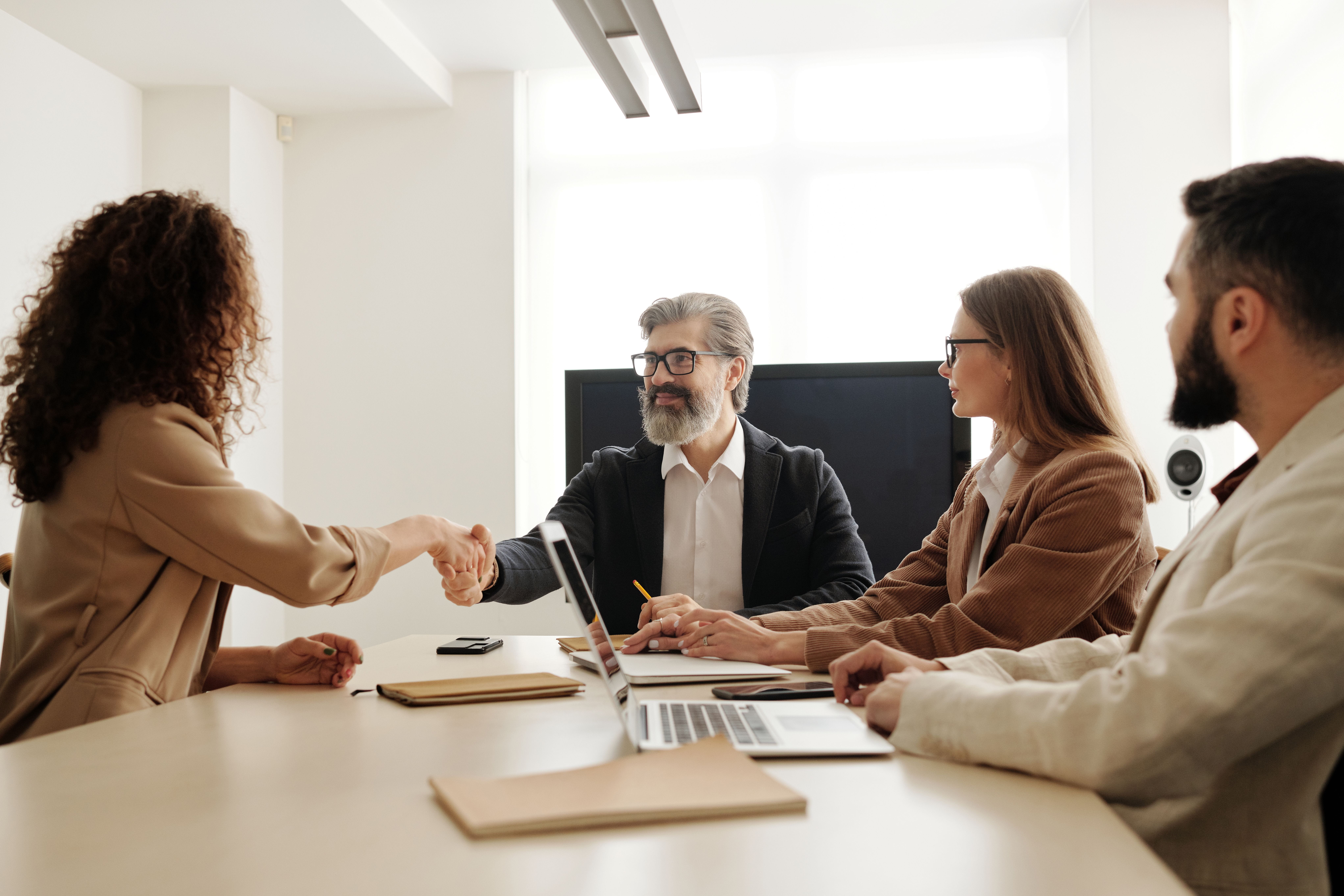 Two people shaking hands after an interview.