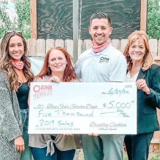 Chunk Nibbles presents a check for $5,000 based on their 2019 sales to Blue Star Service Dogs.