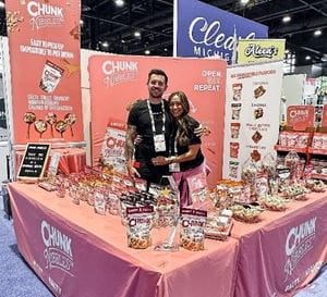 Brad and Katie Cocklin with the Chunk Nibbles booth at Sweets & Snacks Expo 2023.