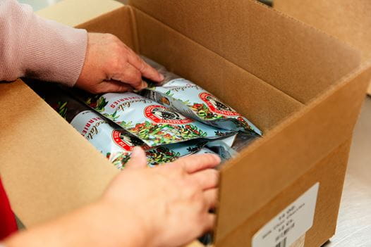 Milk chocolate covered cherry products in product boxes.