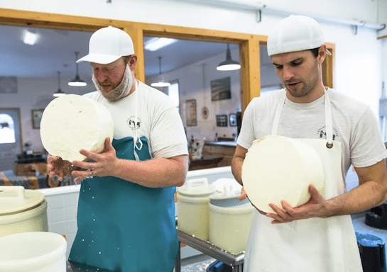 Image of artisan cheese makers.