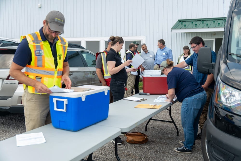 A group of people organizing components for an emergency.