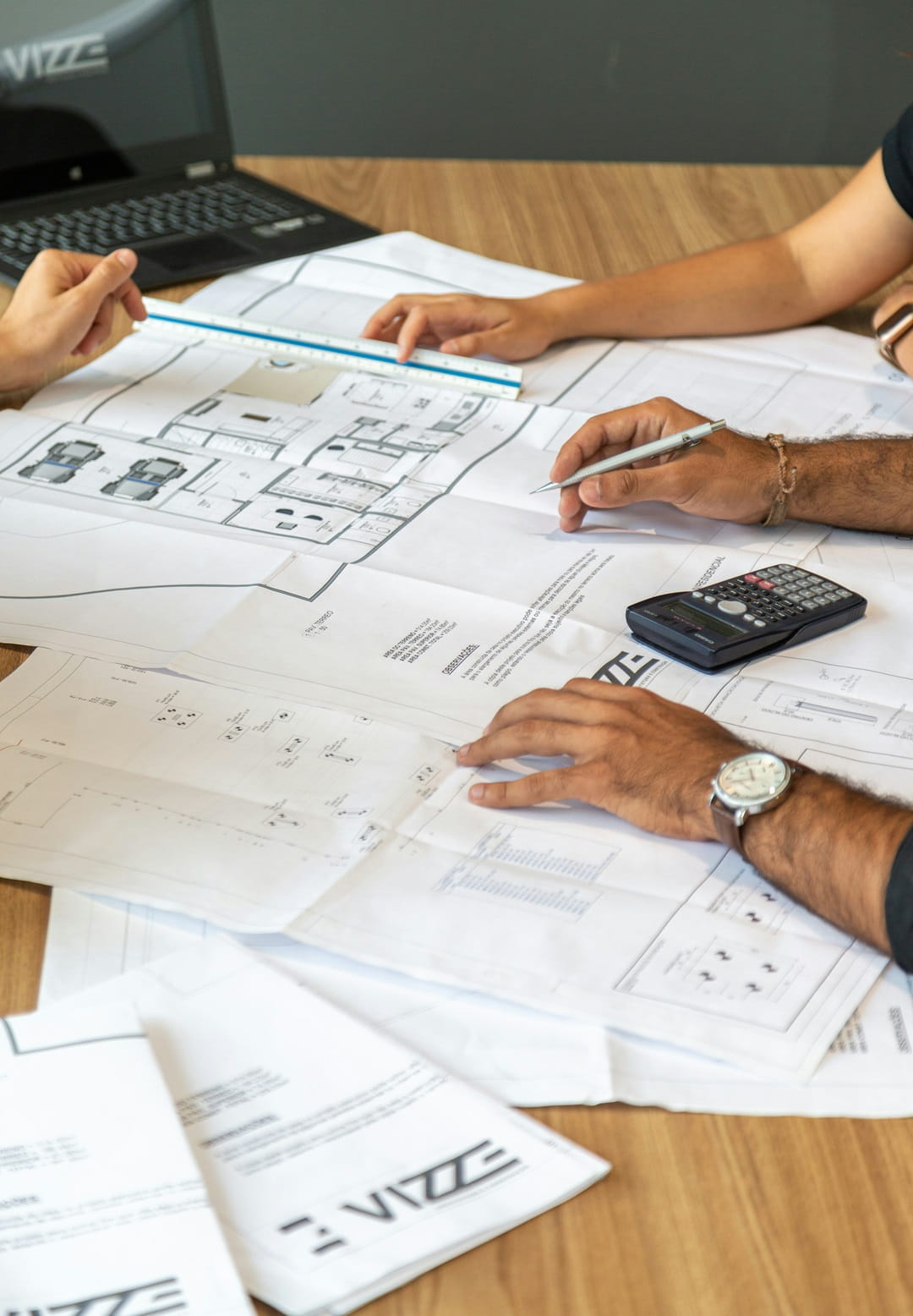 Several people working together on a floor plan.