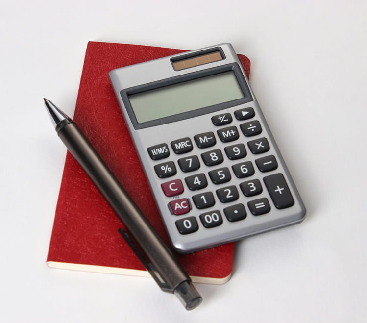 Calculating equipment in the office using books, calculators and pens