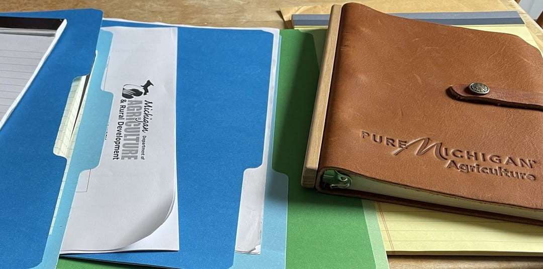Several forms and notebooks in a stack.