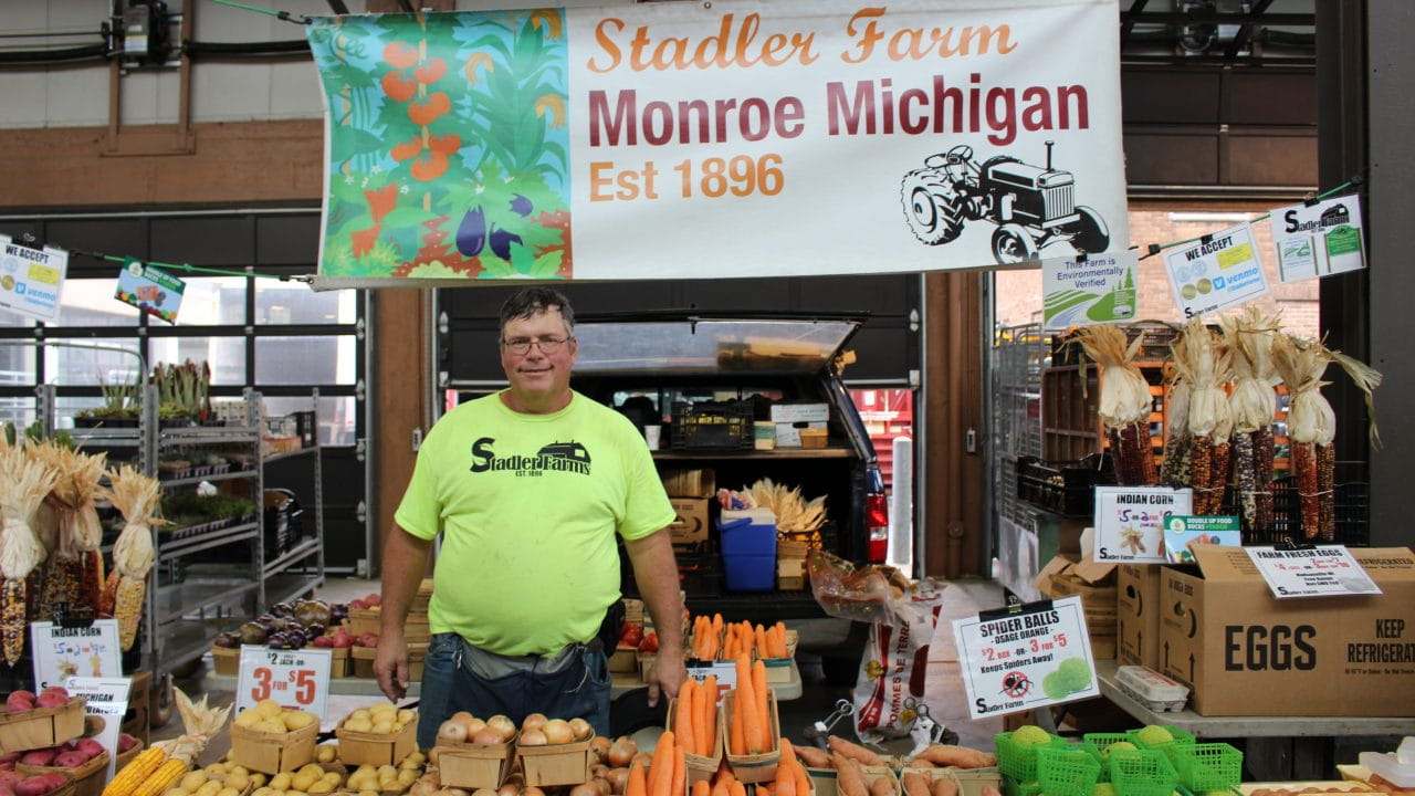 Ron Stadler standing behind a farm stand