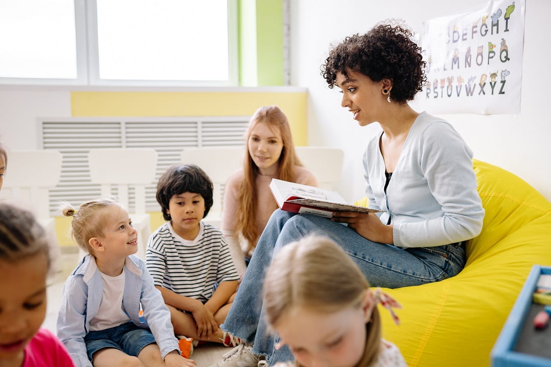 Woman reading to children in classroom