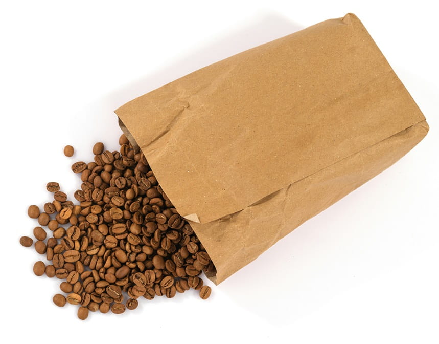 A collection of coffee beans pouring out of a bag.
