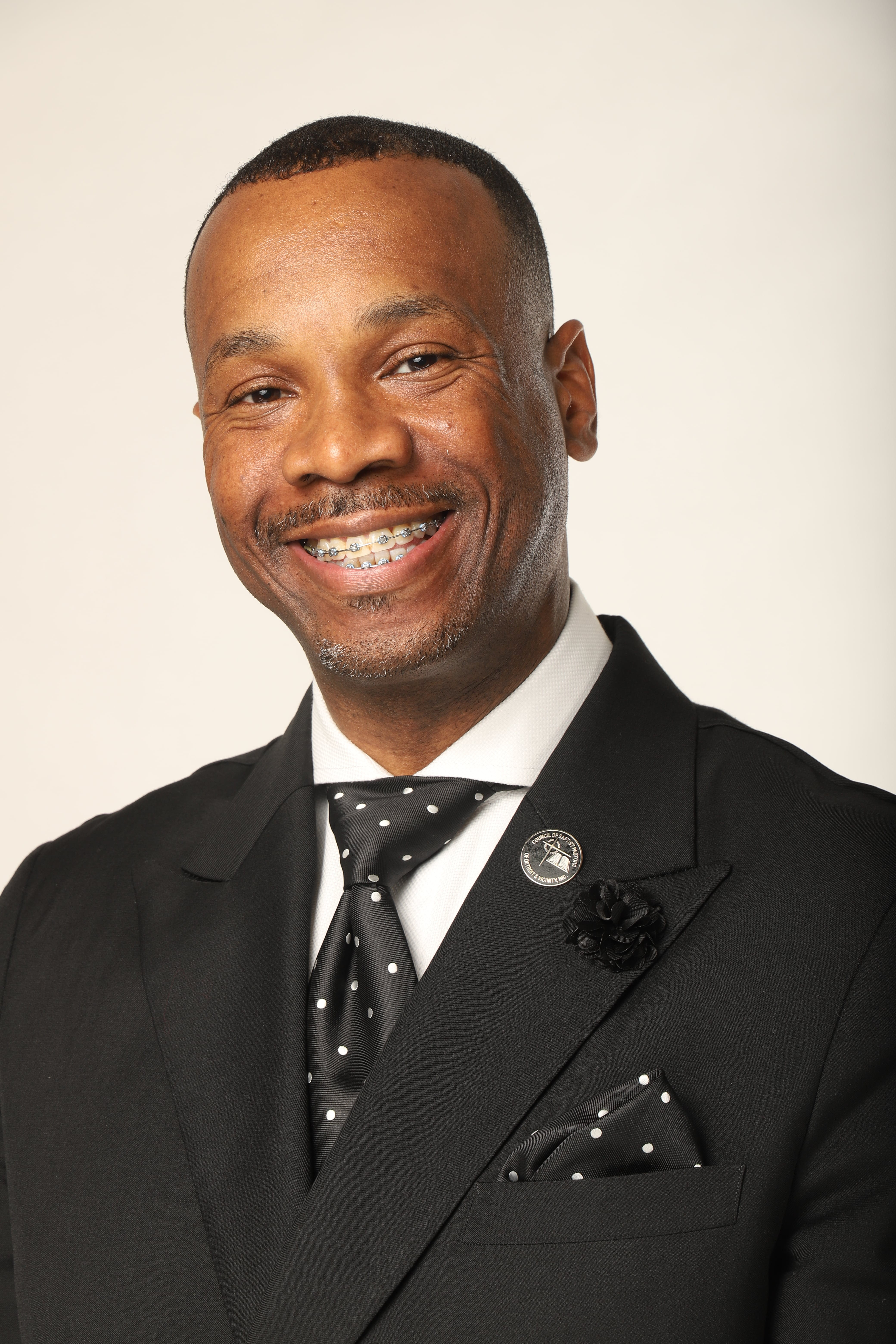 Richard White looks at the camera smiling with a slightly tilted head. He