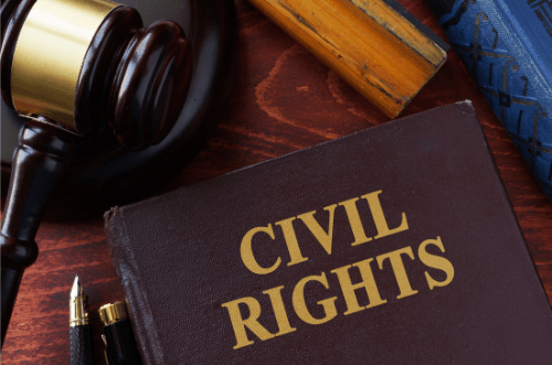 Photo of a book titled "Civil Rights" and a judges gavel on a wooden desk.