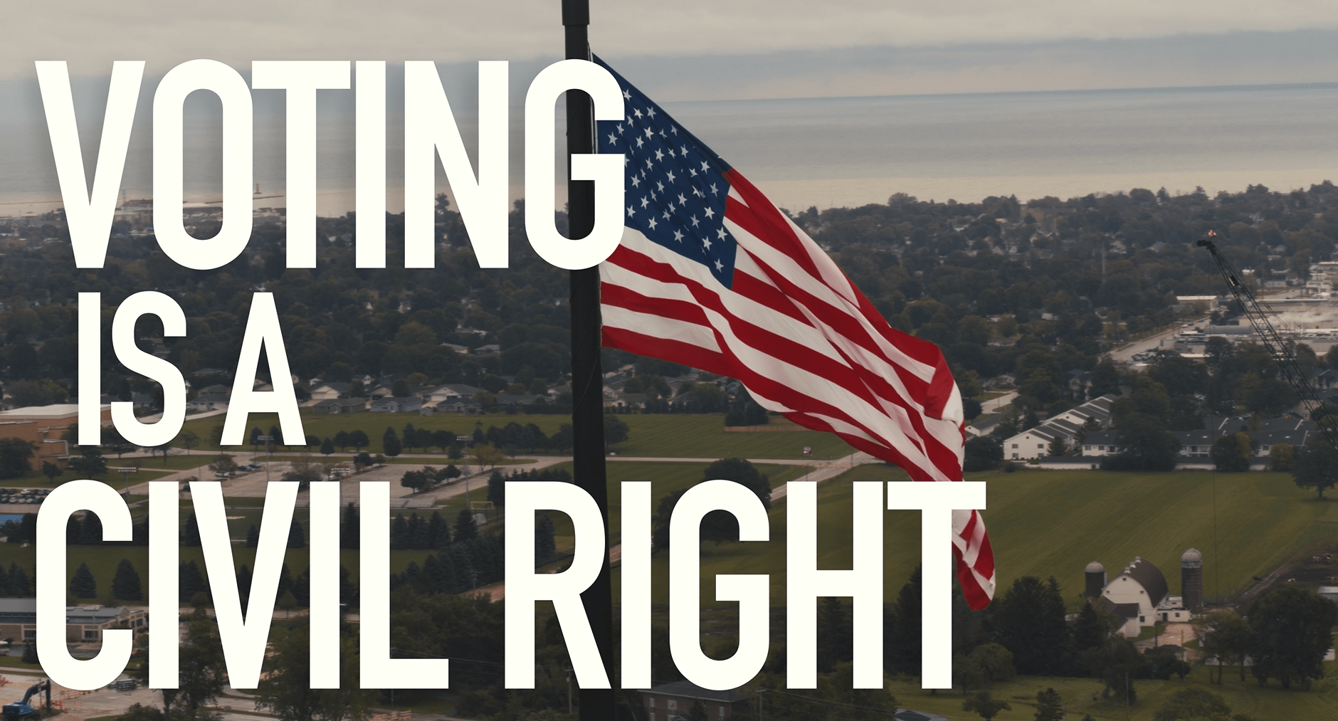 Image of an American flag waving in the breeze with the words "Voting is a Civil Right" on the screen