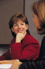 Woman Smiling and resting chin on her fist
