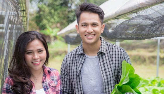Two students in a greenhouse
