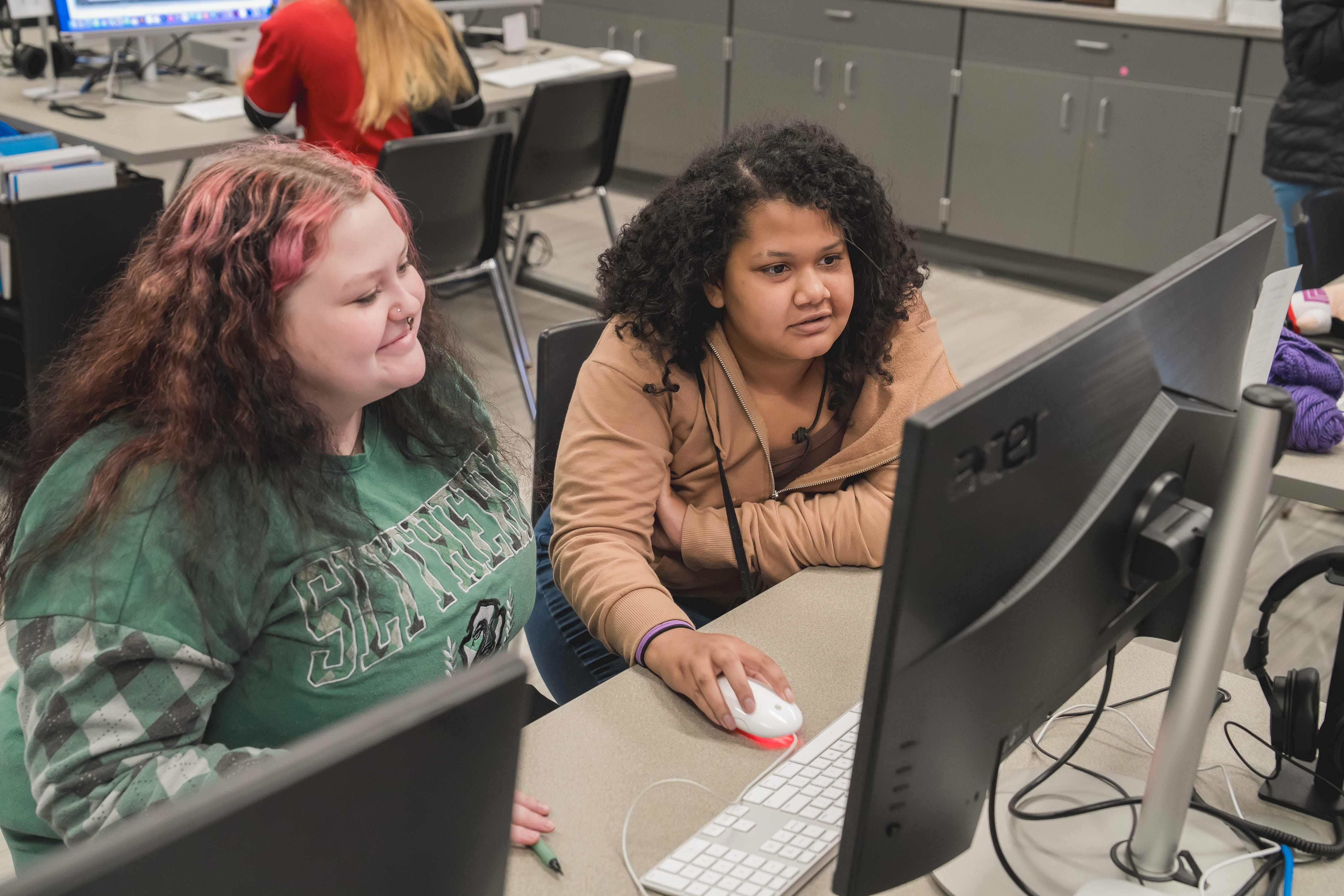 Two female students working on a computer.