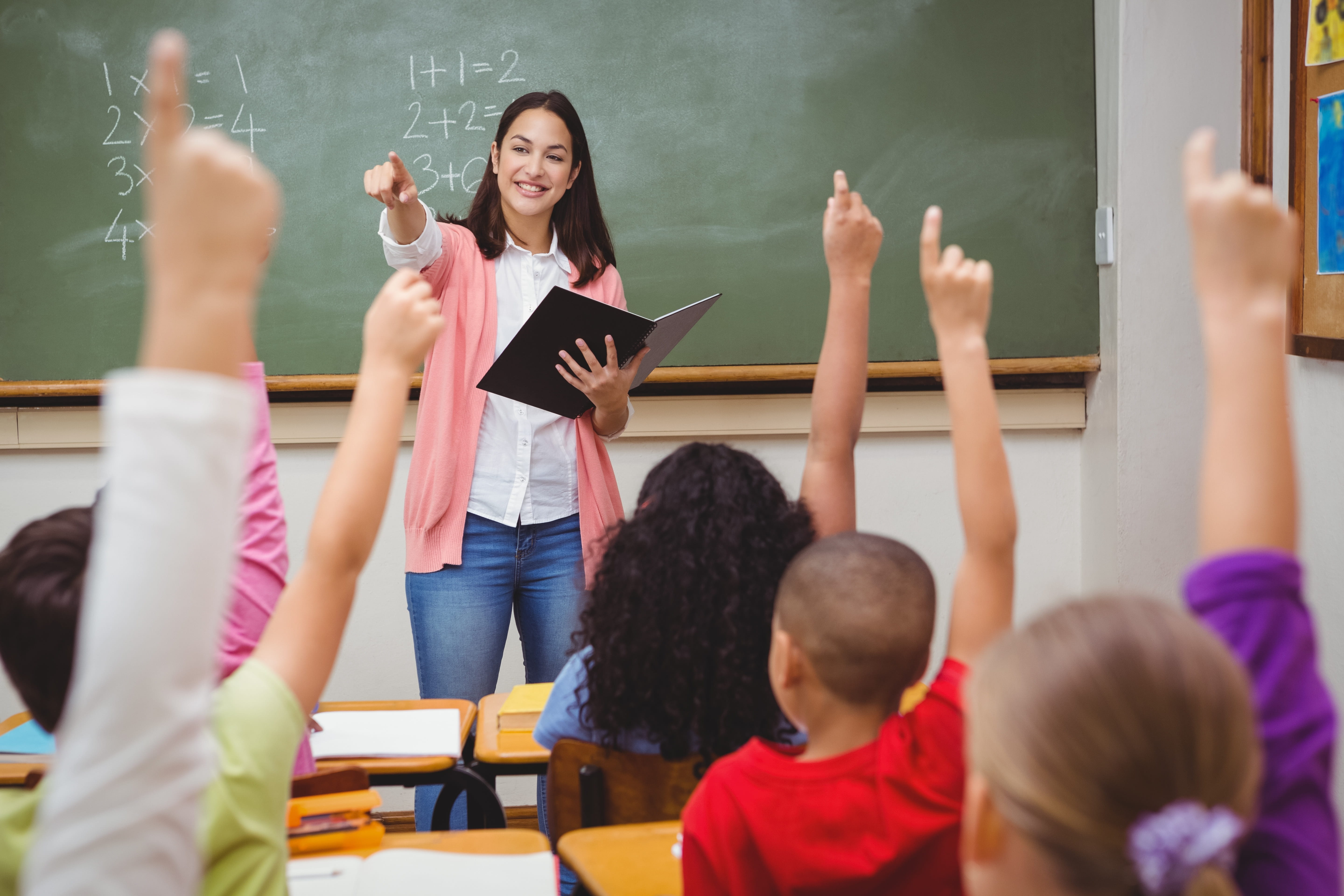 students raising hands