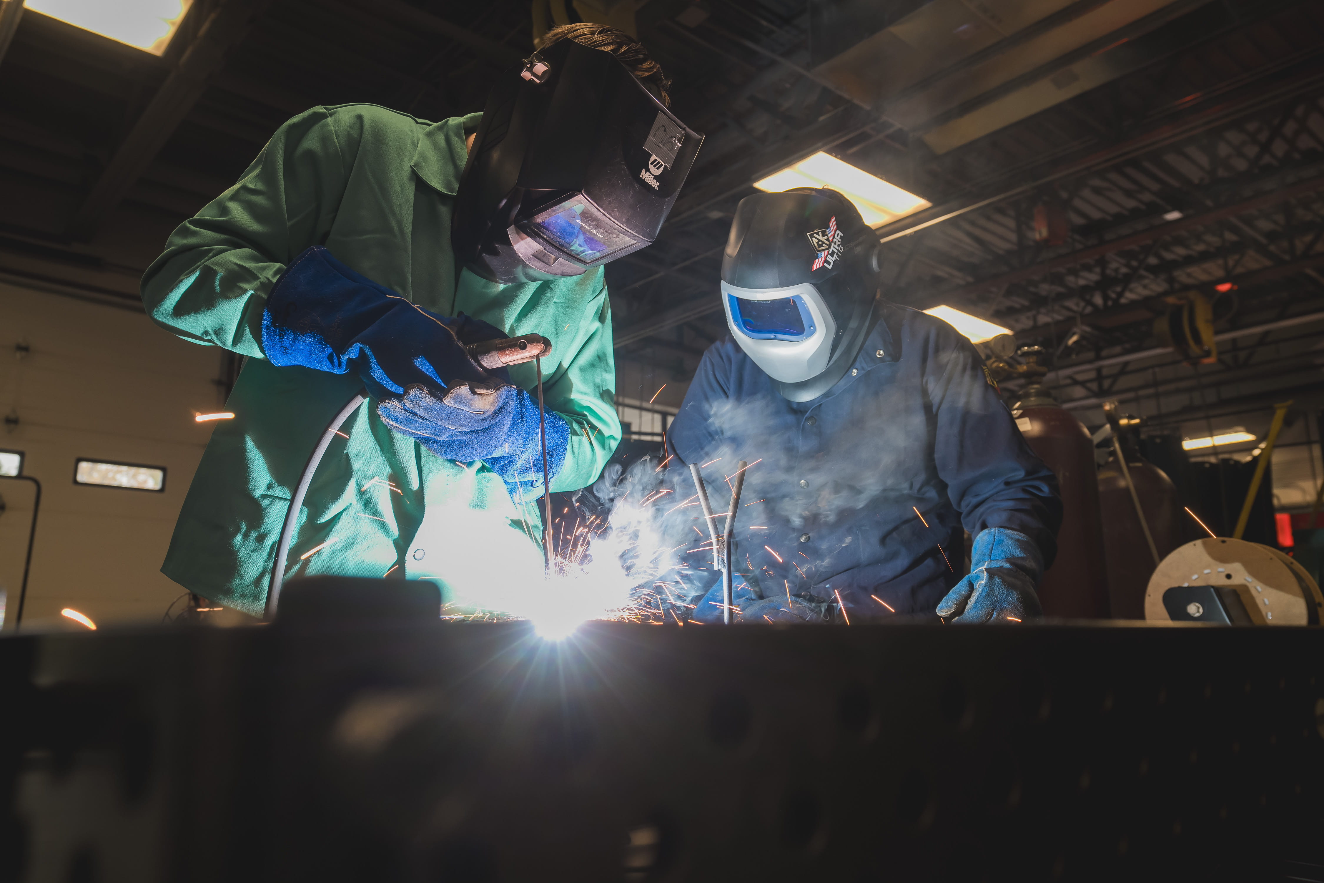 Two students welding. 