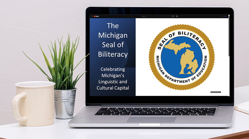 Laptop with Michigan Seal of Biliteracy Webinar on screen.