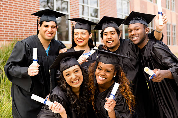 group of diverse high school students in cap and gown on graduation day