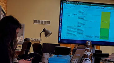 Research and Data icon displaying an image of a person multi-tasking