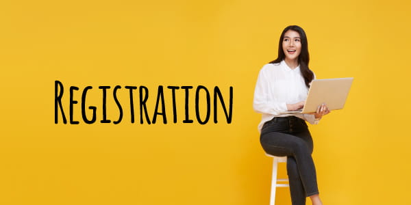Hispanic woman holding open laptop with "Registration" on the screen