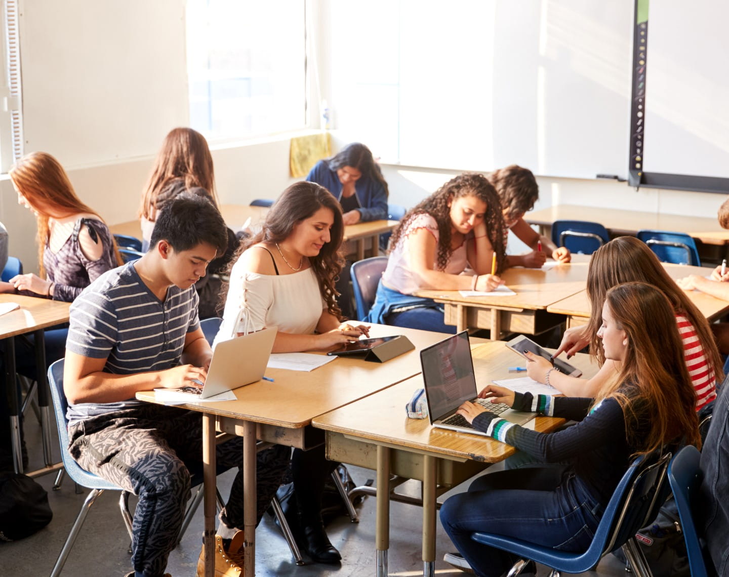 A high school classroom scene with students working at their desks