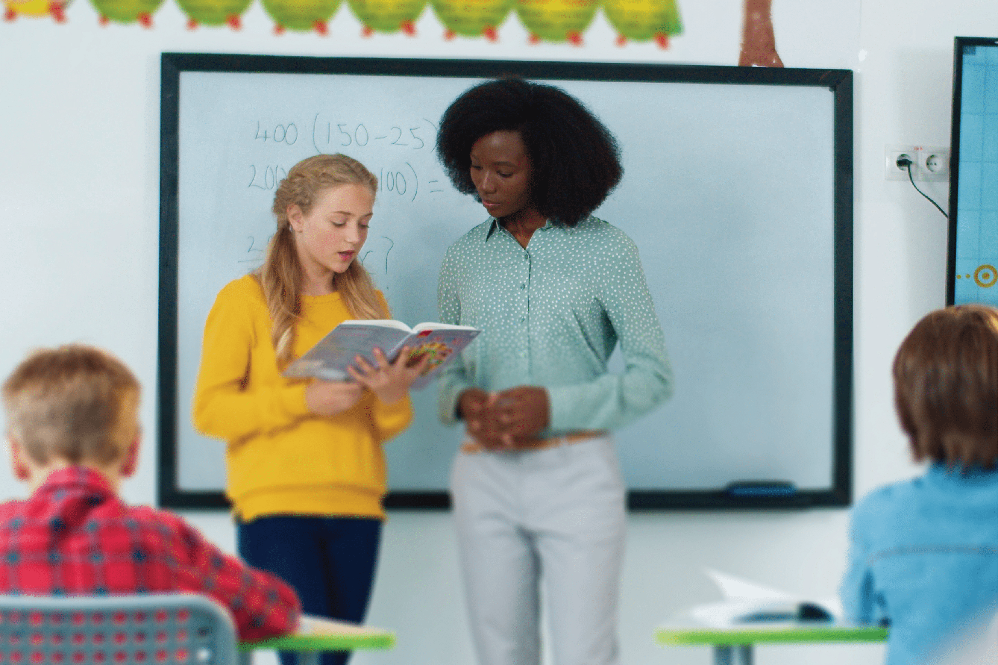 teacher and student looking over materials together
