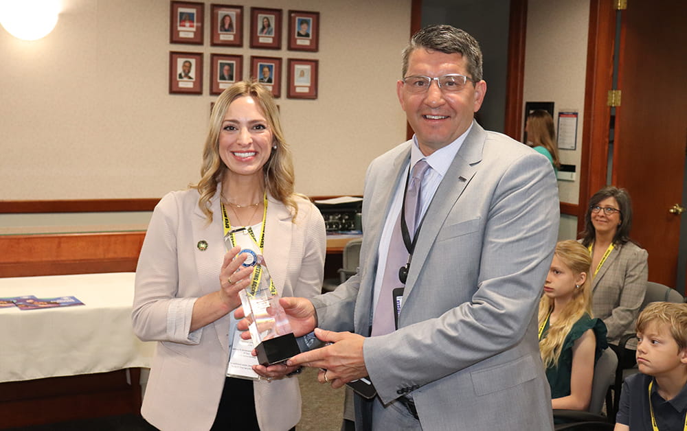 State Superintendent of Public Instruction Dr. Glenn Maleyko presents Pine River Middle School teacher Stephanie Johnson with her 2025 Milken Educator Award. 