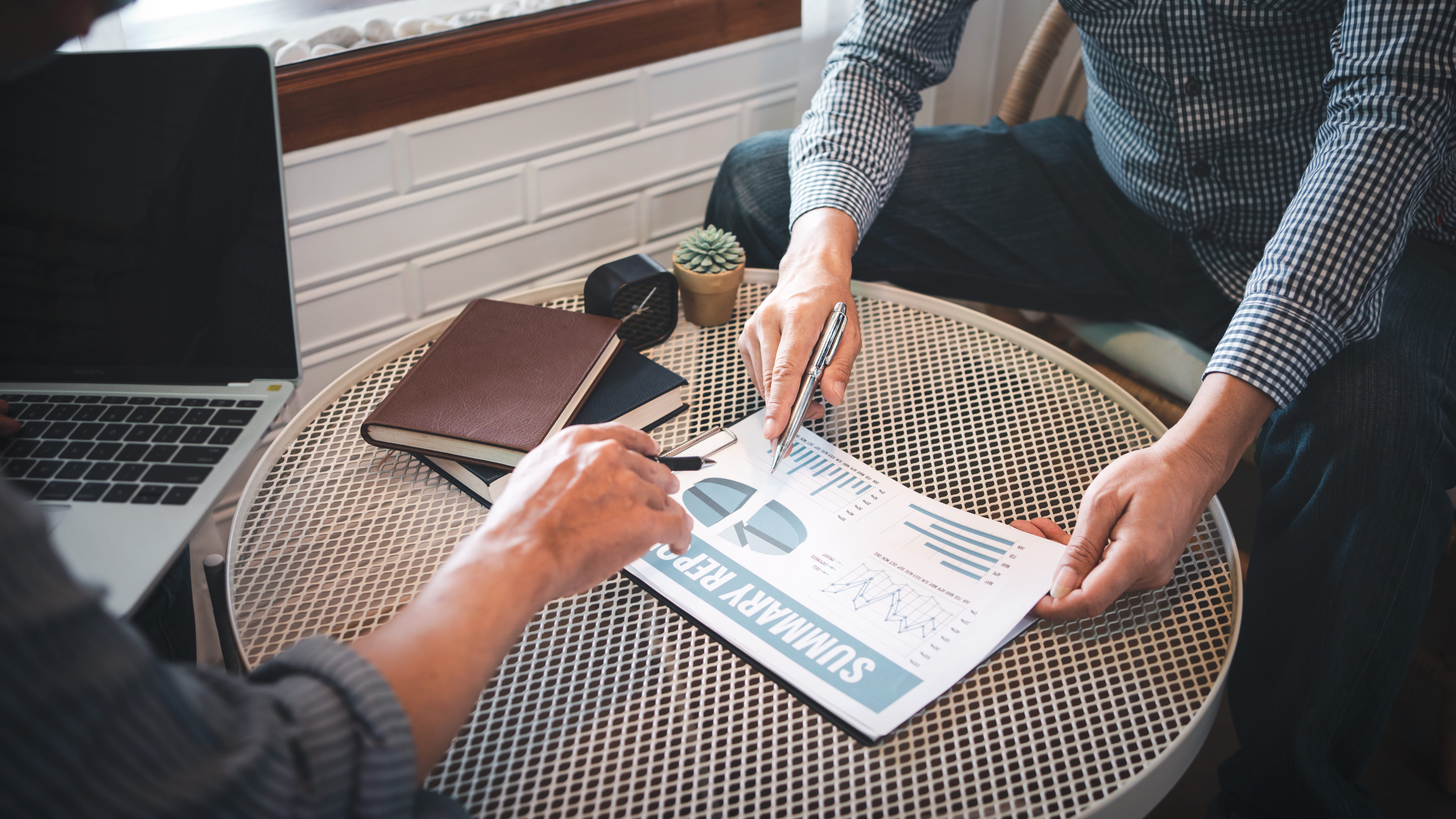two people looking at a publication