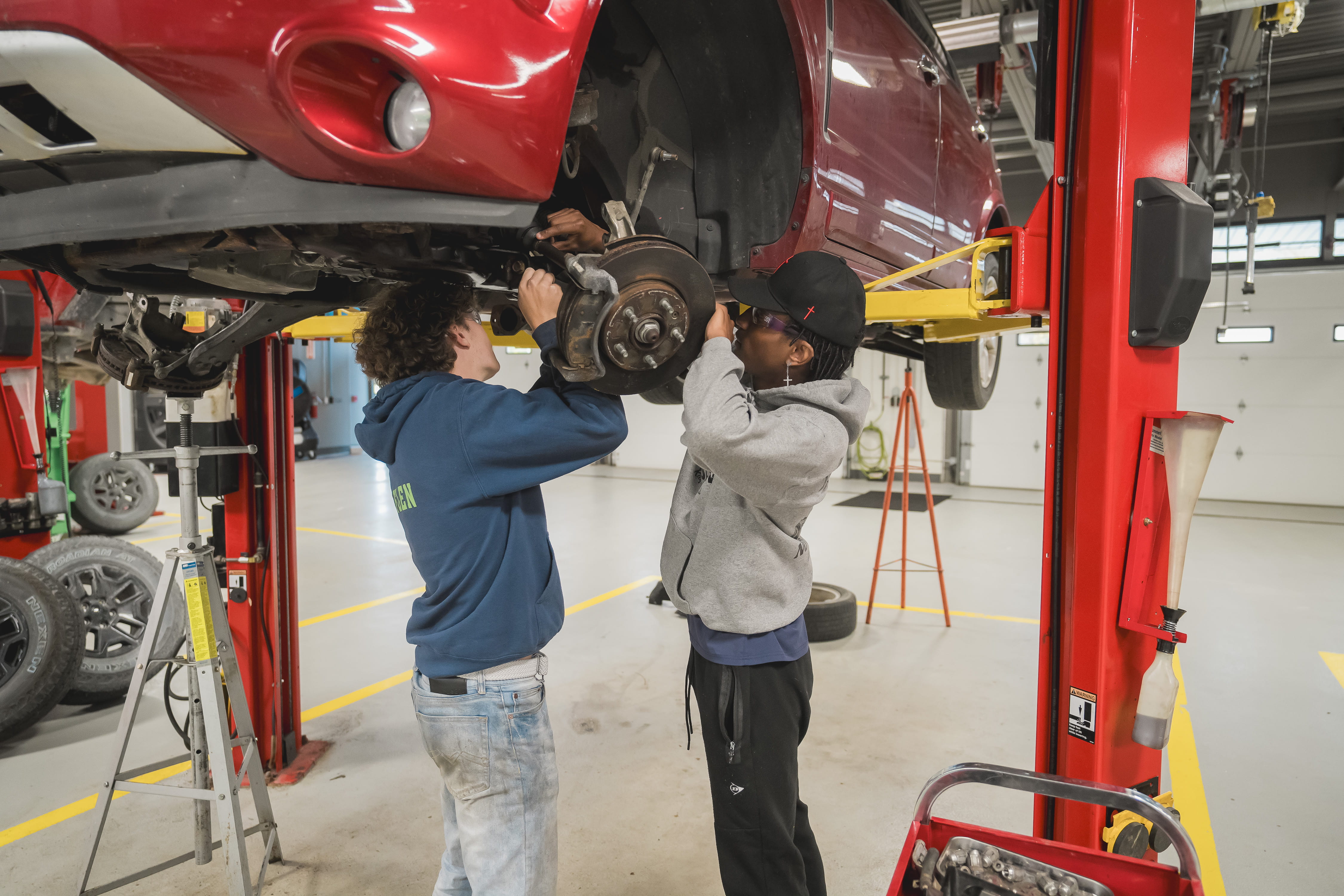 Automotive students working on a car