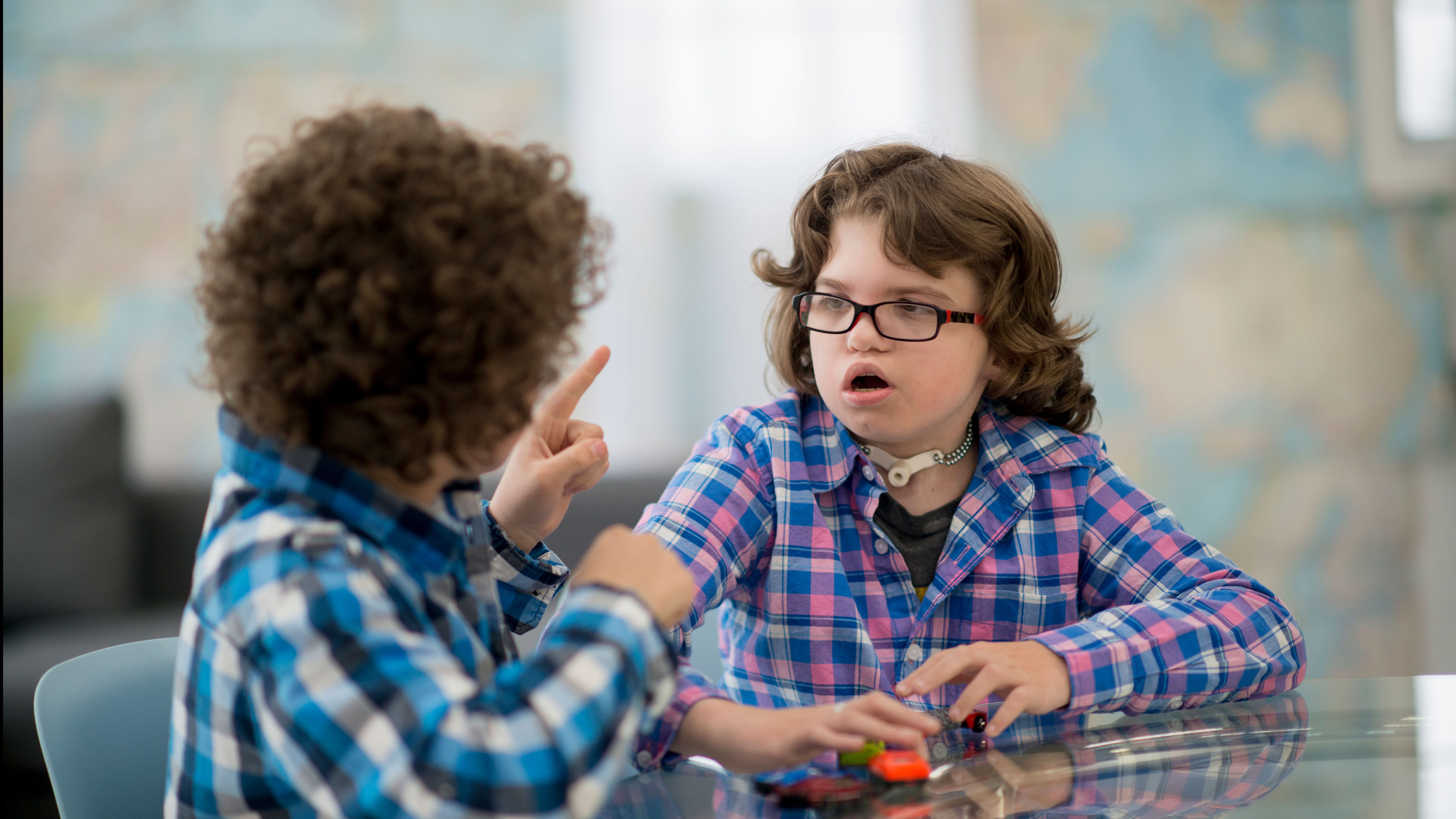 A child signs to another child.