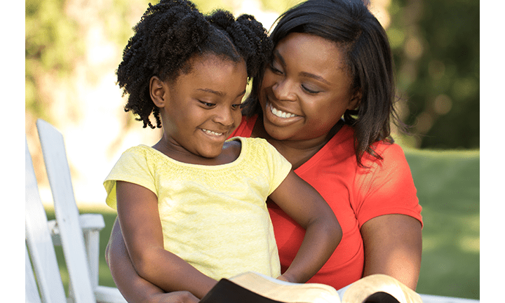 Mother reading to her young daughter