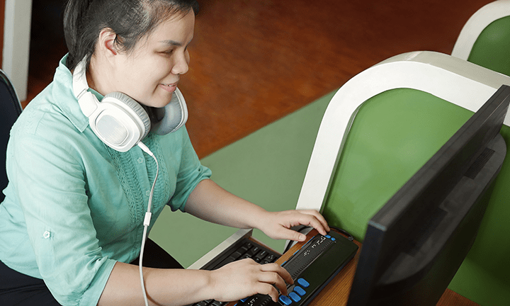 High school student using a Braille writer.