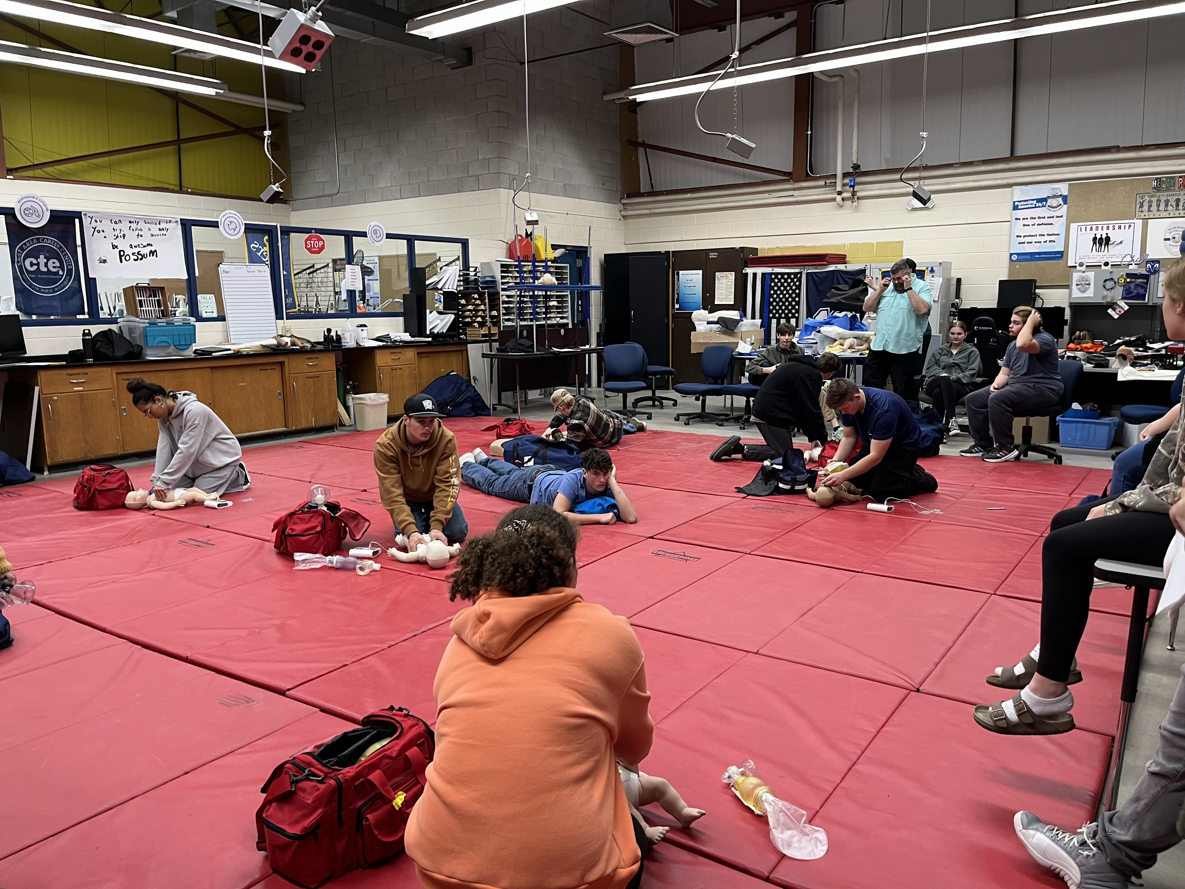 Students from SACC practicing on how to perform CPR on infants