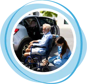 Woman helping elderly man in wheelchair