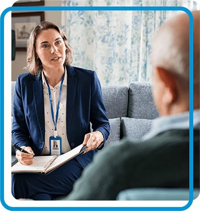 Woman with clipboard talking to senior man
