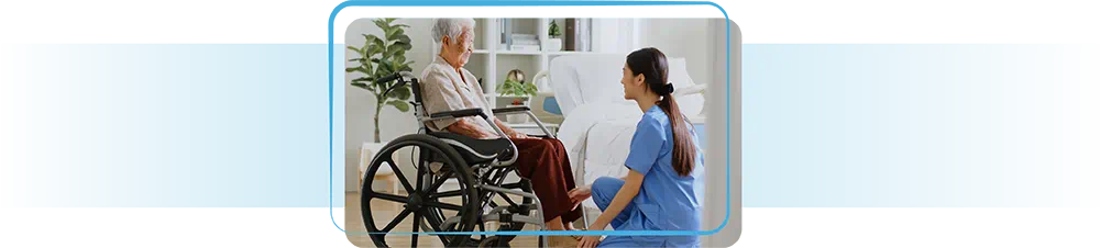 Nurse assisting elderly lady in wheelchair.