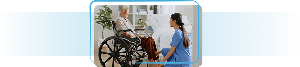 Nurse assisting elderly lady in wheelchair.