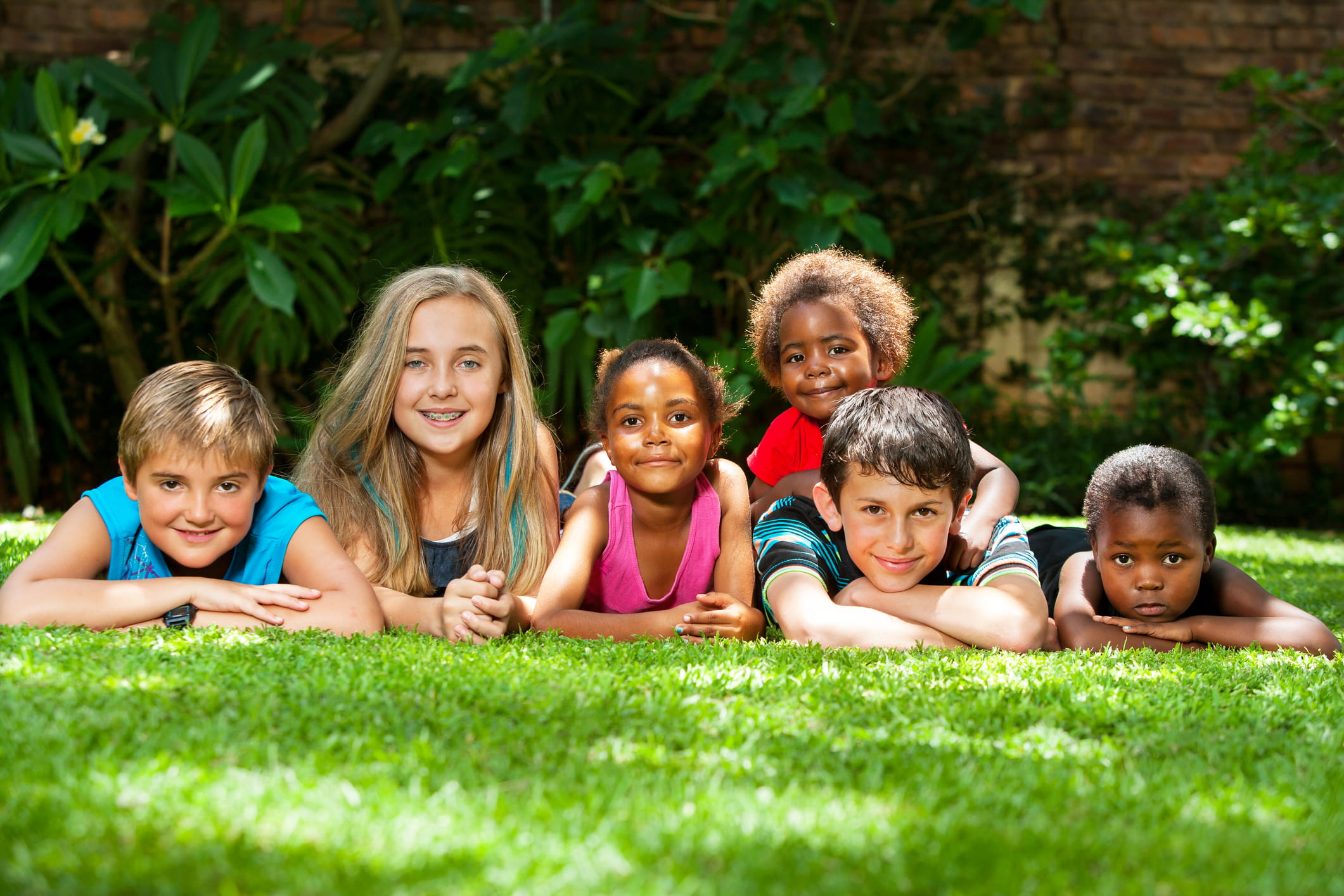 group of children laying on the grass