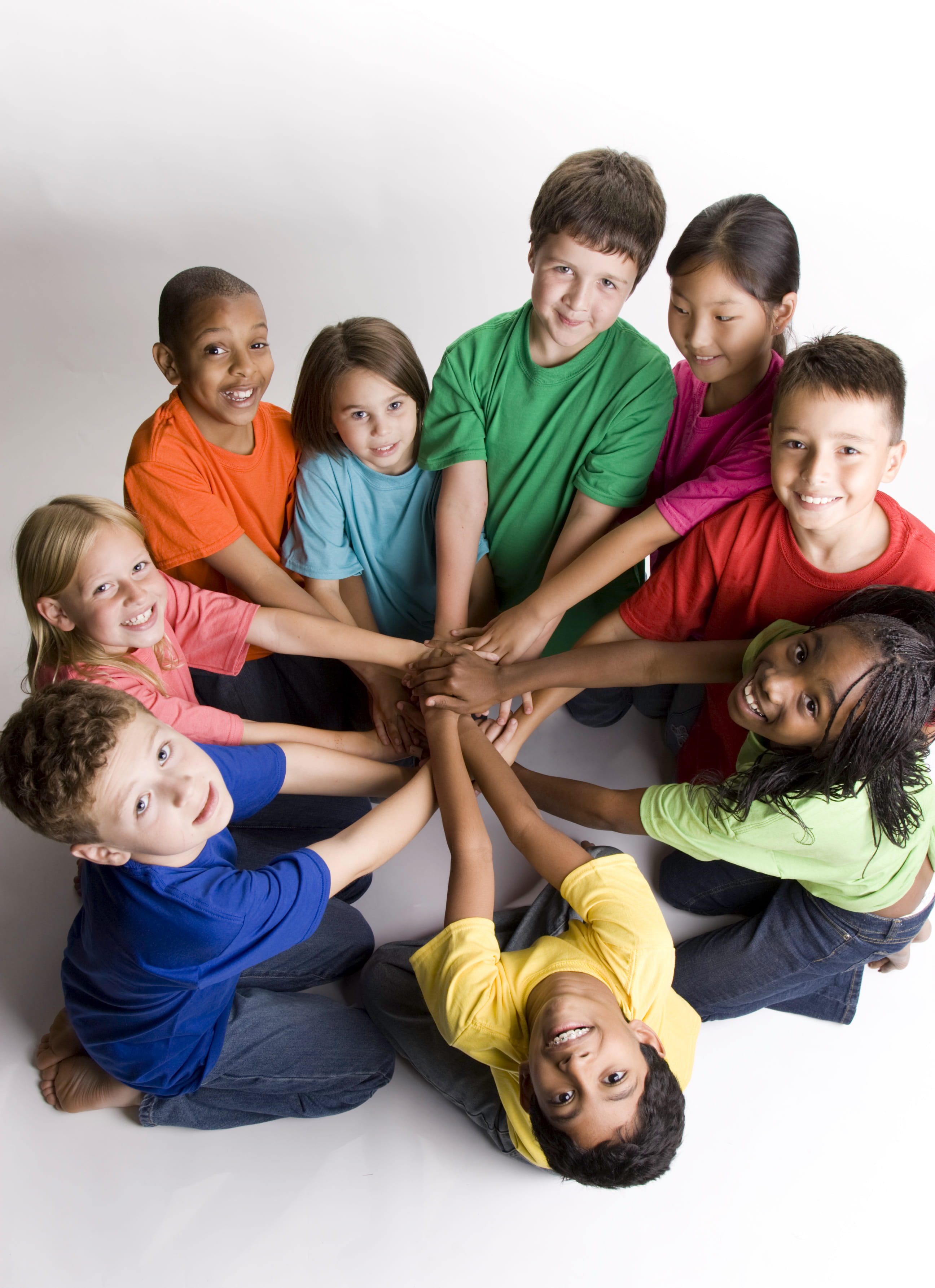 Children putting hands together in circle