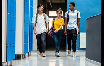 adolescents walking in school hallway