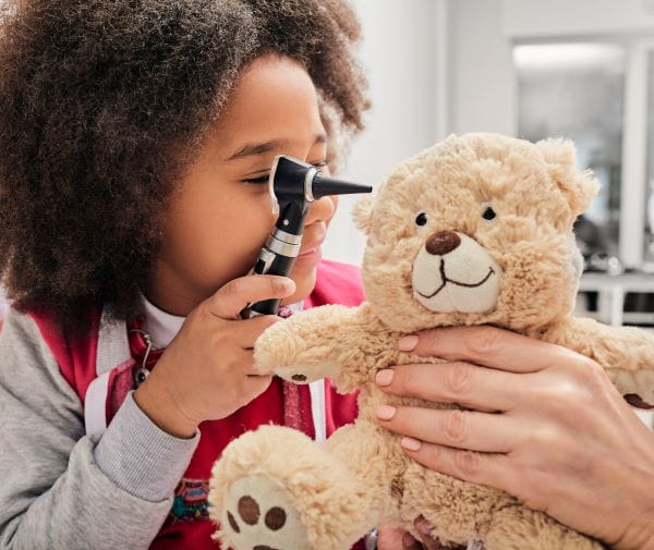 Child examining teddy bear