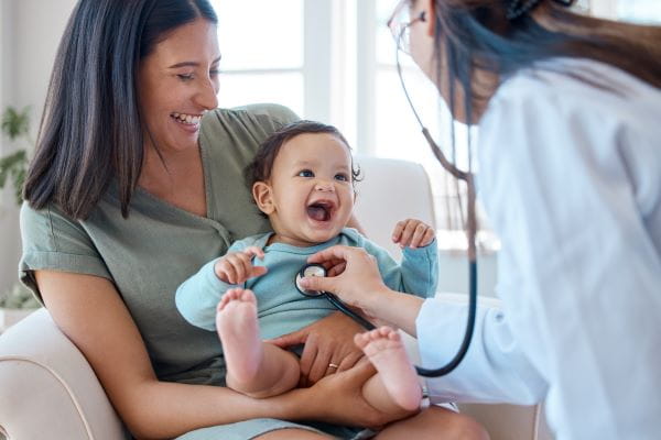 Woman and infant being examined by doctor