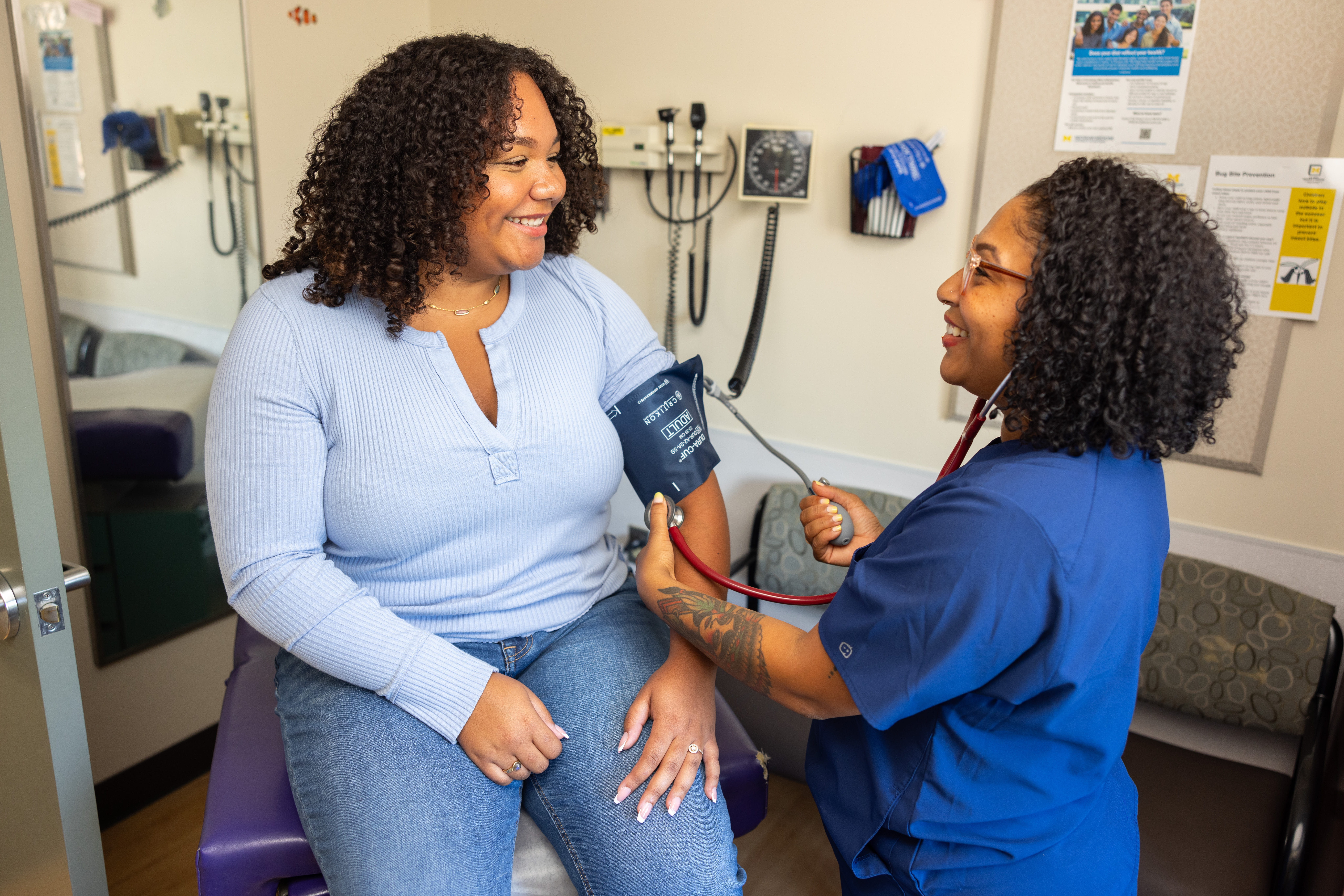 Provider taking the blood pressure of a young patient