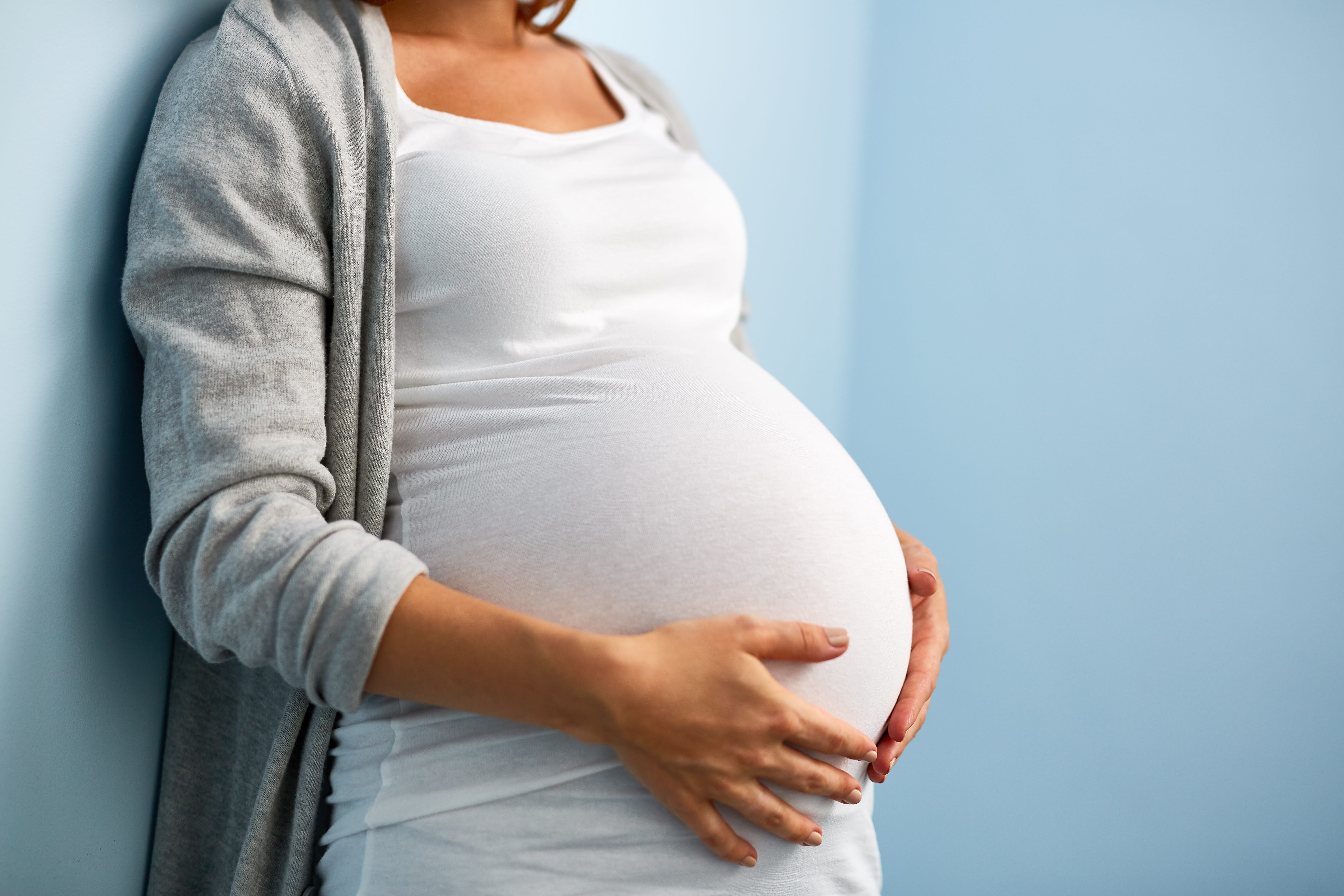 pregnant woman holding stomach