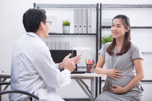pregnant woman consulting with doctor
