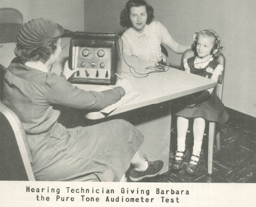 Hearing Tech Giving Barbara the Pure Tone Audiometer Test