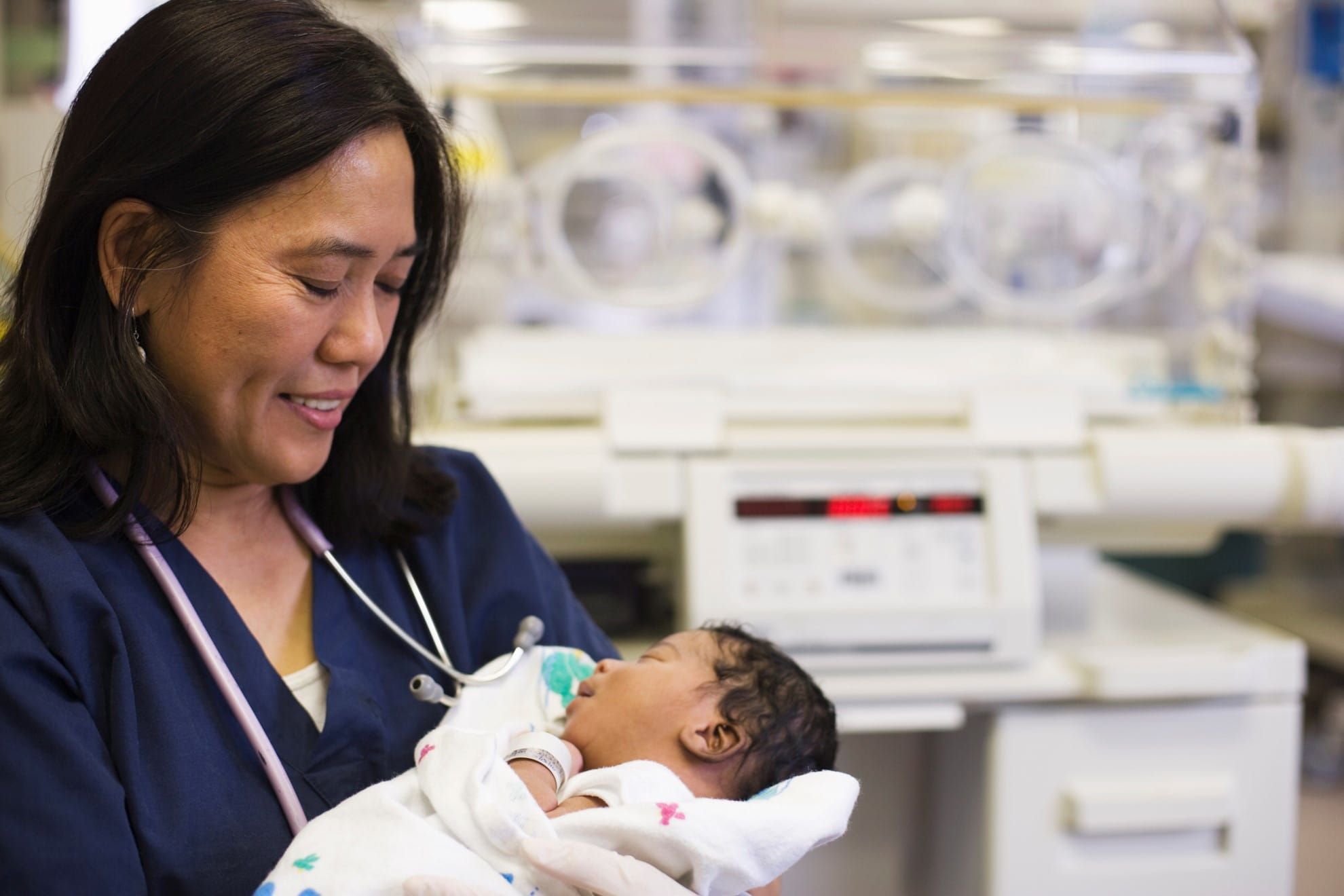 image of nurse holding baby at hospital